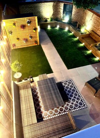 Illuminated courtyard garden with water feature and modern paving